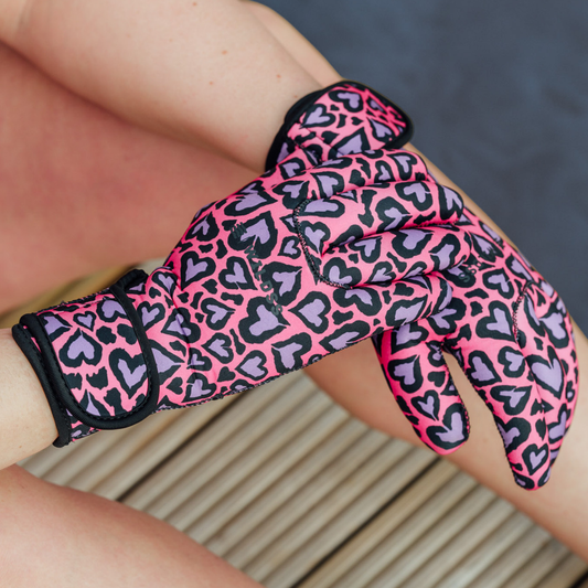 Pink and black leopard print neoprene glove on a person's hand