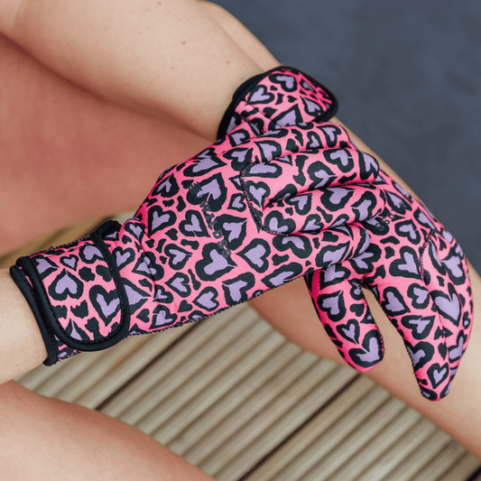 Pink and black leopard print neoprene glove on a person's hand