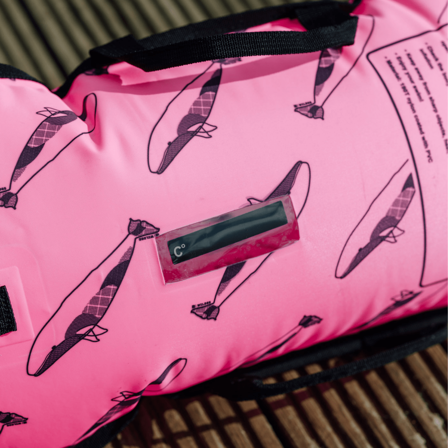 Pink tow float with black whale pattern and a digital temperature gauge.