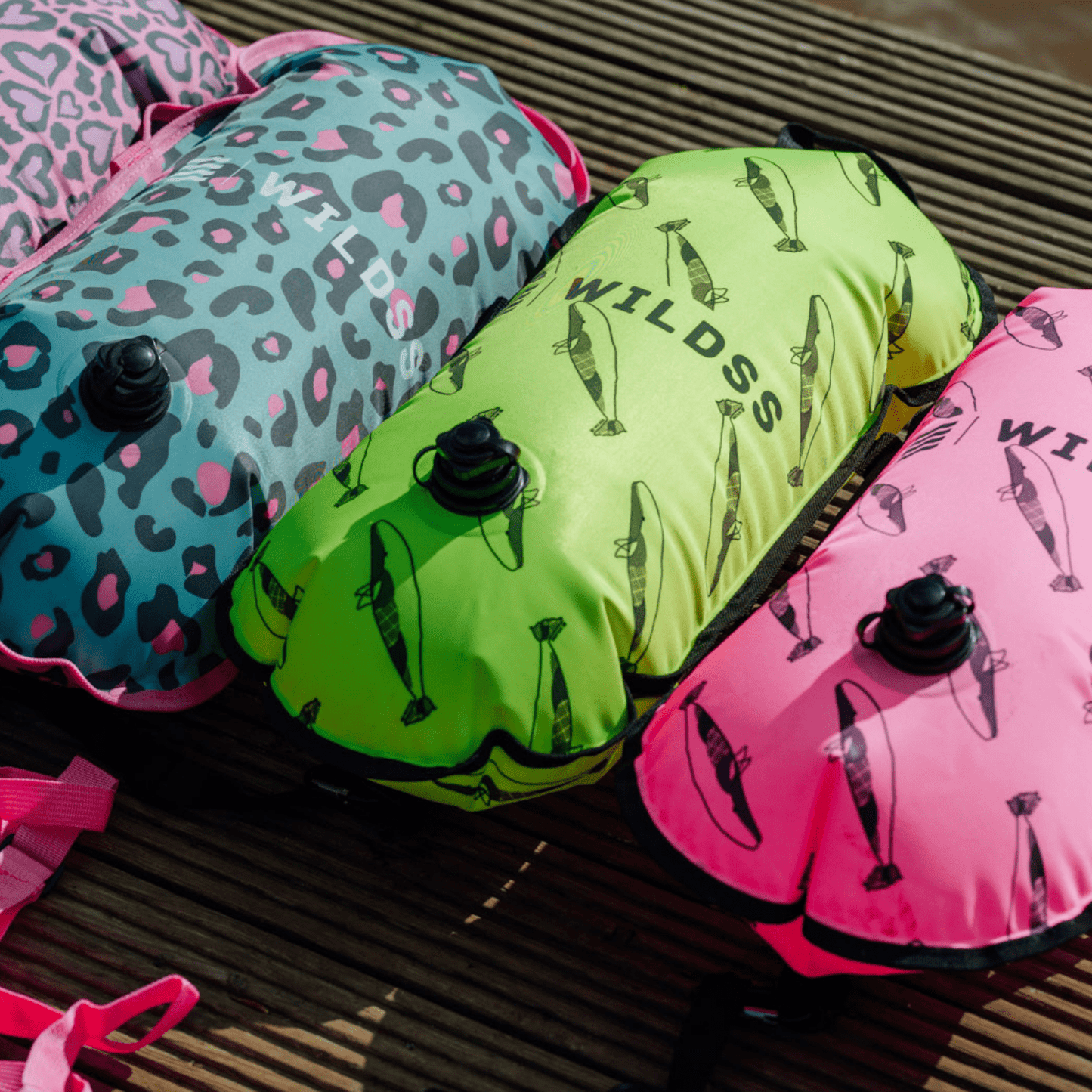 Inflatable colourful tow floats on a wooden dock