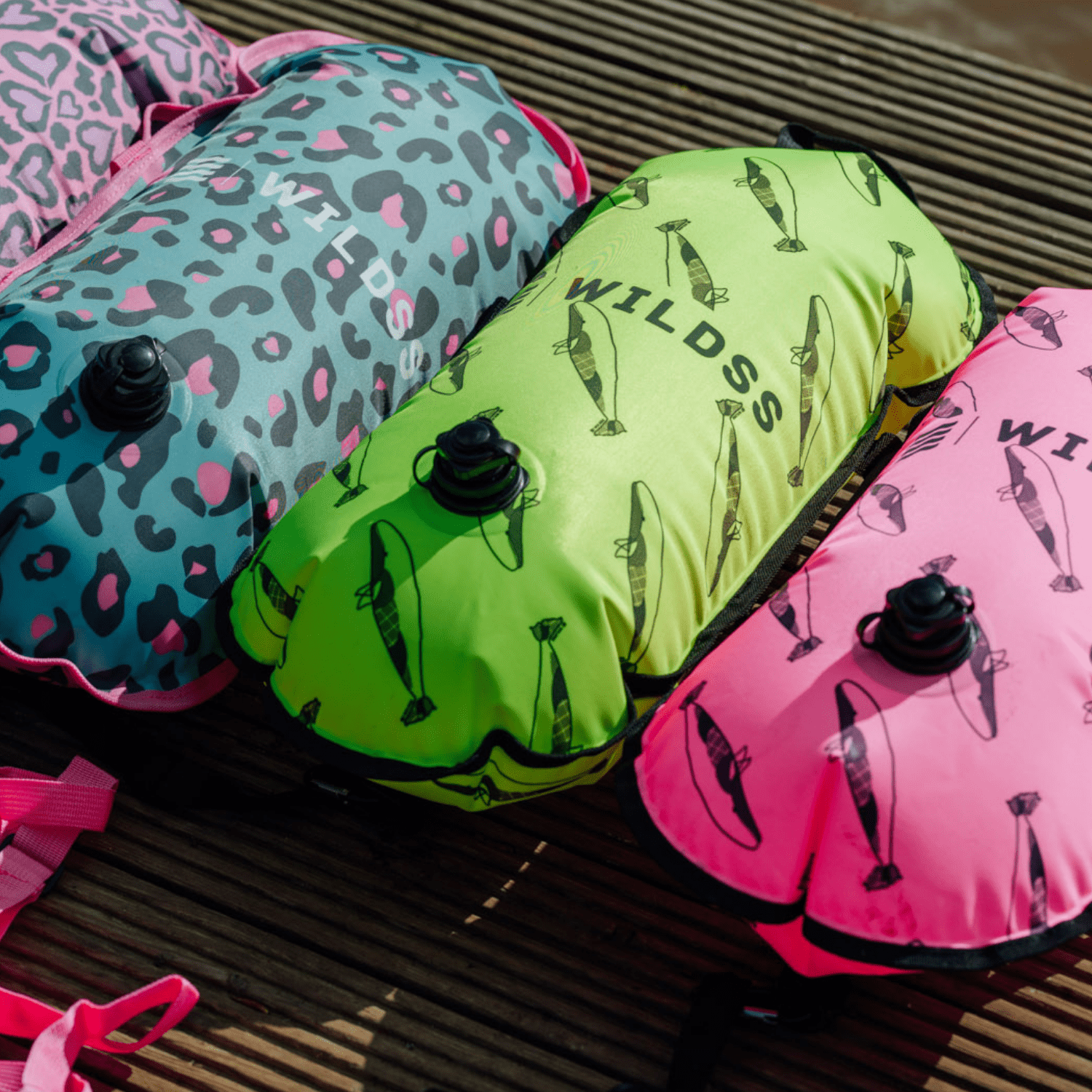 Inflatable colourful tow floats on a wooden dock