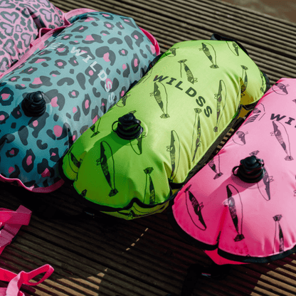 Inflatable colourful tow floats on a wooden dock