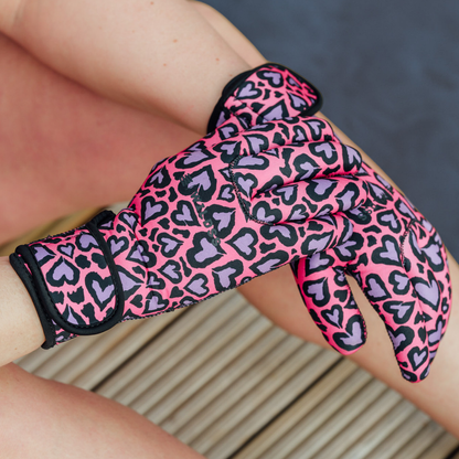 Pink and black leopard print neoprene glove on a person's hand